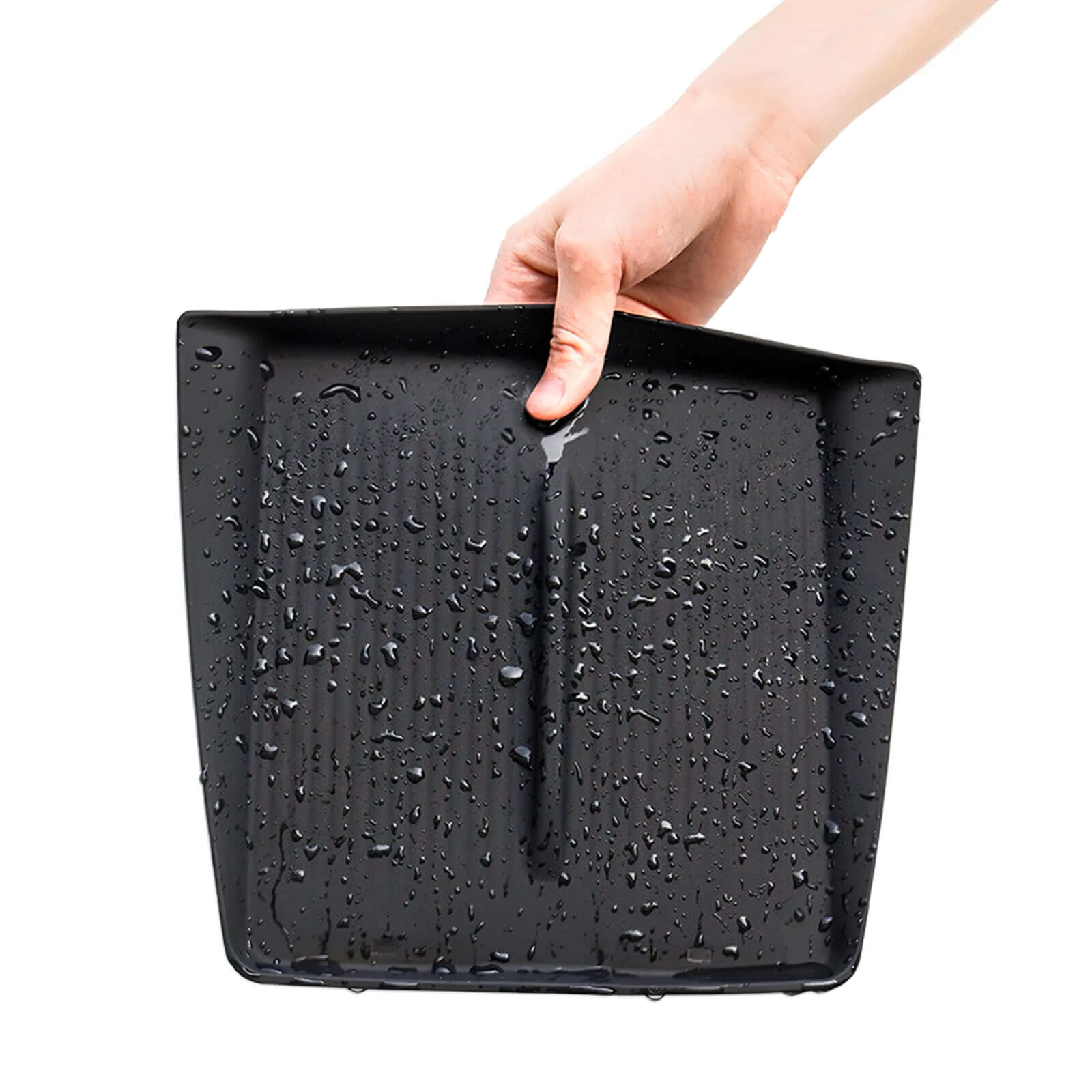 Close-up of Tesla Model Y Juniper 2025 & Model 3 Highland console wireless charging pad showing water-resistant silicone material