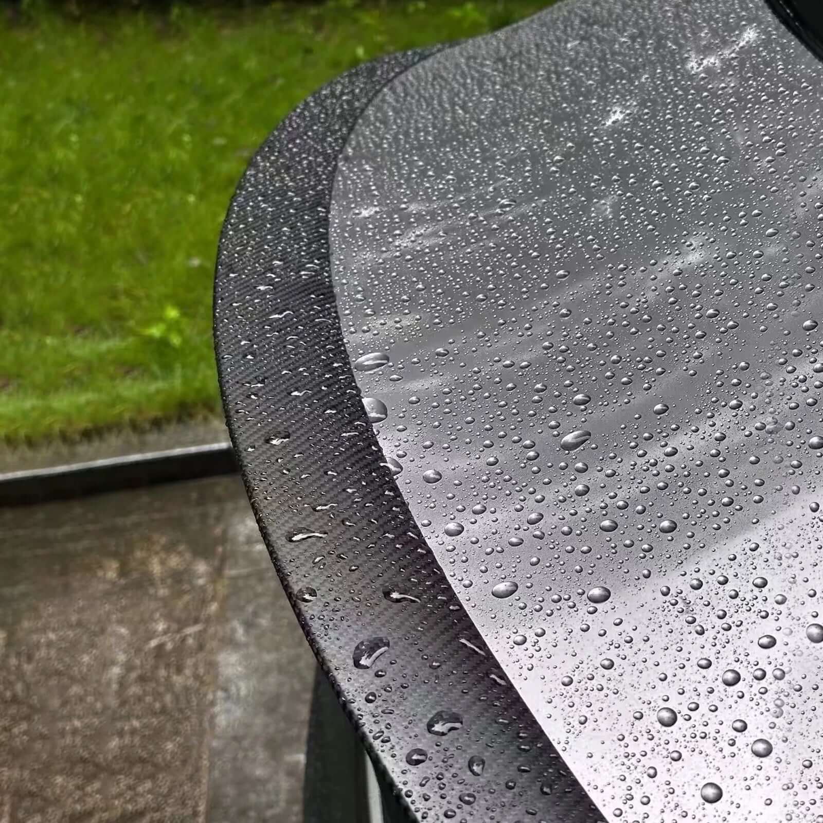 Close-up of Real Dry Carbon Spoiler for Tesla Model 3 Highland 2024 showing water-resistant surface with droplets