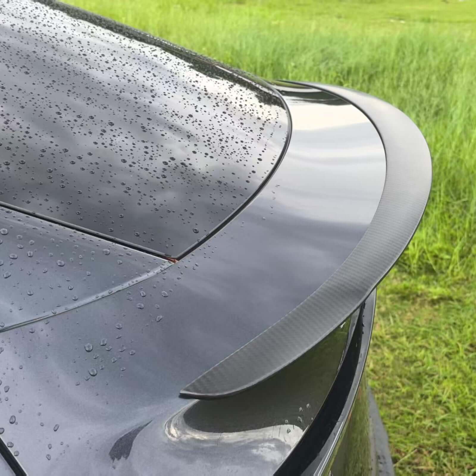 Close-up of Real Dry Carbon Spoiler for Tesla Model Y Juniper 2025 showcasing glossy finish and aerodynamic design