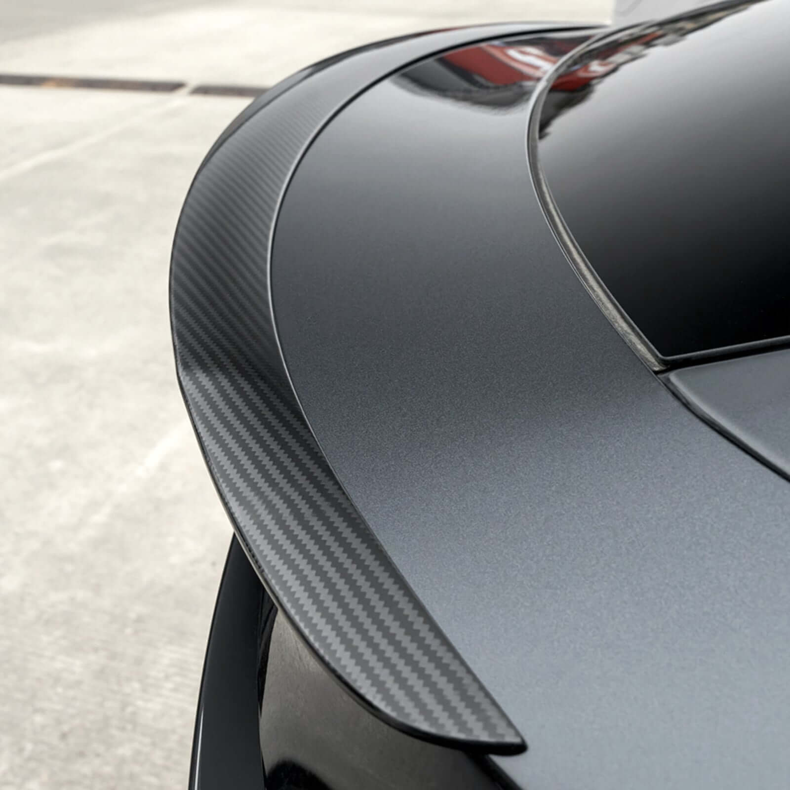 Close-up of Real Dry Carbon Spoiler for Tesla Model Y Juniper 2025 showing 3K twill texture and sleek finish