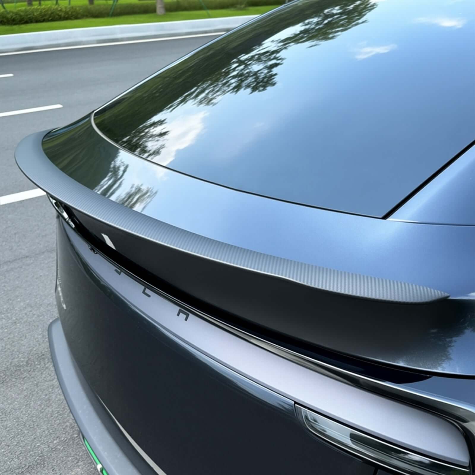 Tesla Model Y Juniper 2025 real dry carbon spoiler installed showing OEM performance look and aerodynamic design