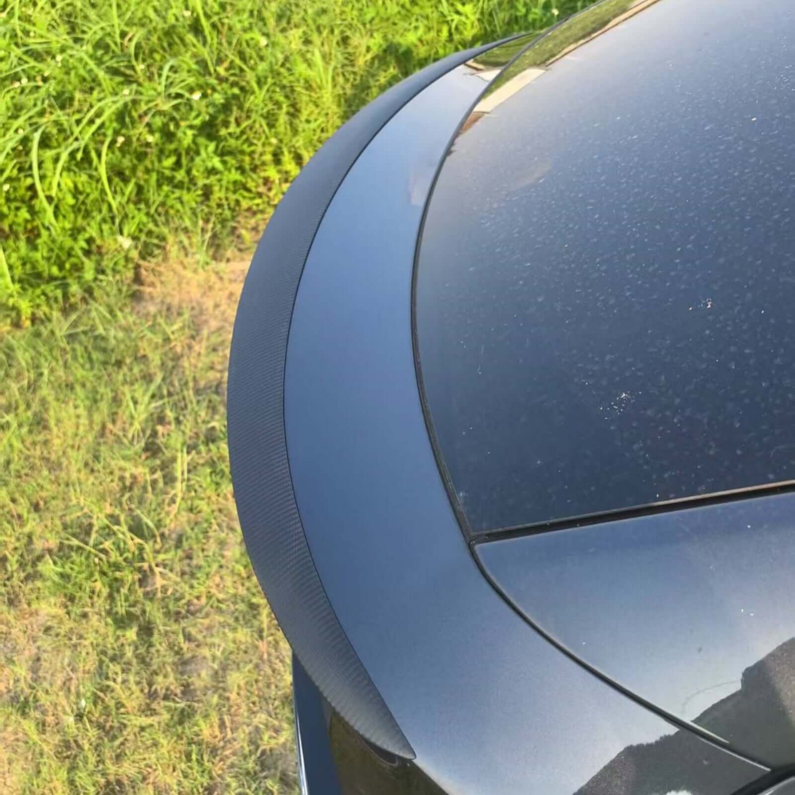 Top view of Real Dry Carbon Spoiler for Tesla Model Y Juniper 2025 showing OEM performance fit and finish