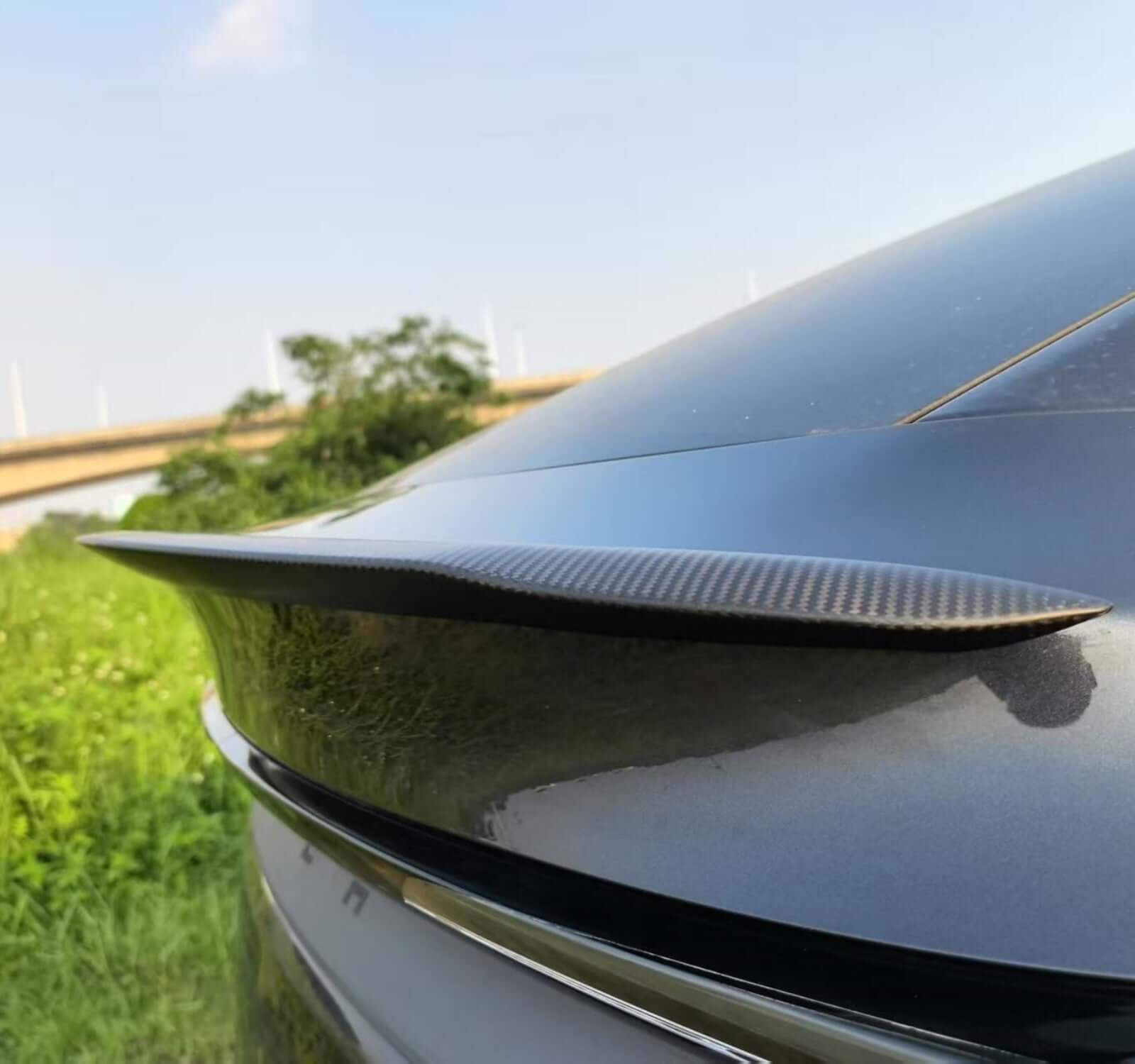 Side view of Real Dry Carbon Spoiler for Tesla Model Y Juniper 2025 showing sleek design and aerodynamics